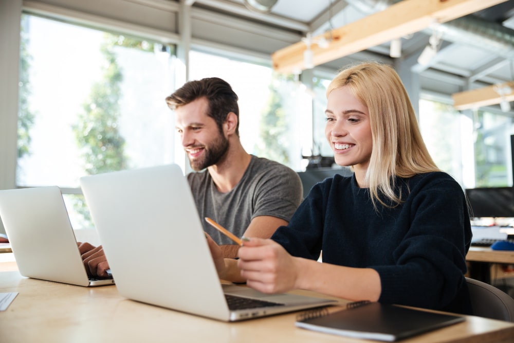 Professionals working on laptops in an office environment supported by laptop hire